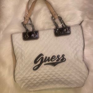 Guess hand bag gently used. black white and peach. w/chain straps, flower inner